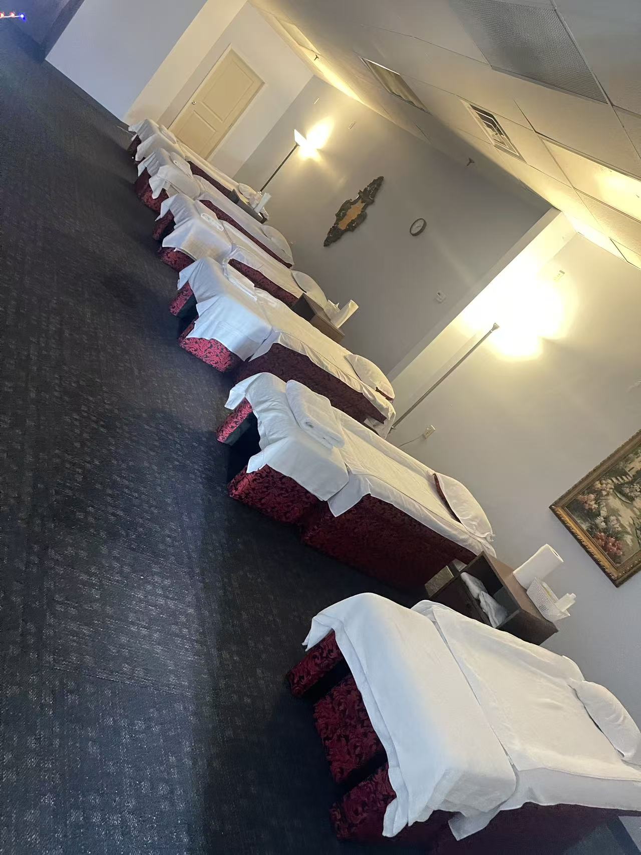Row of massage tables prepared with fresh linens