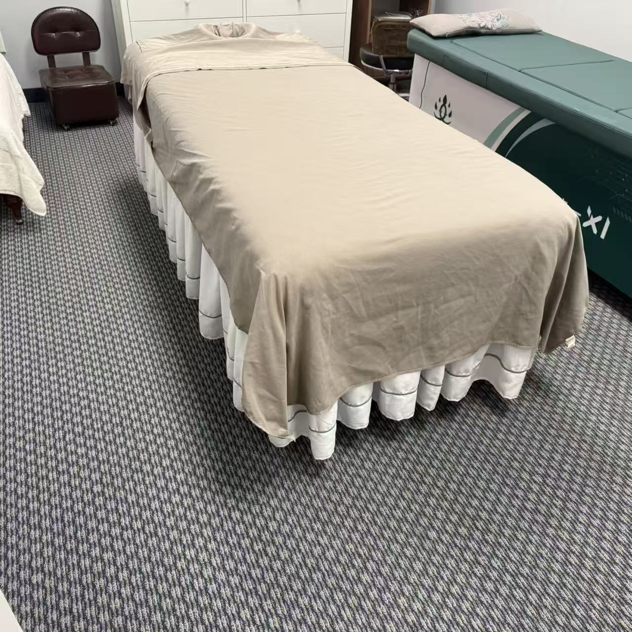 Private treatment room with massage table and moxibustion bed