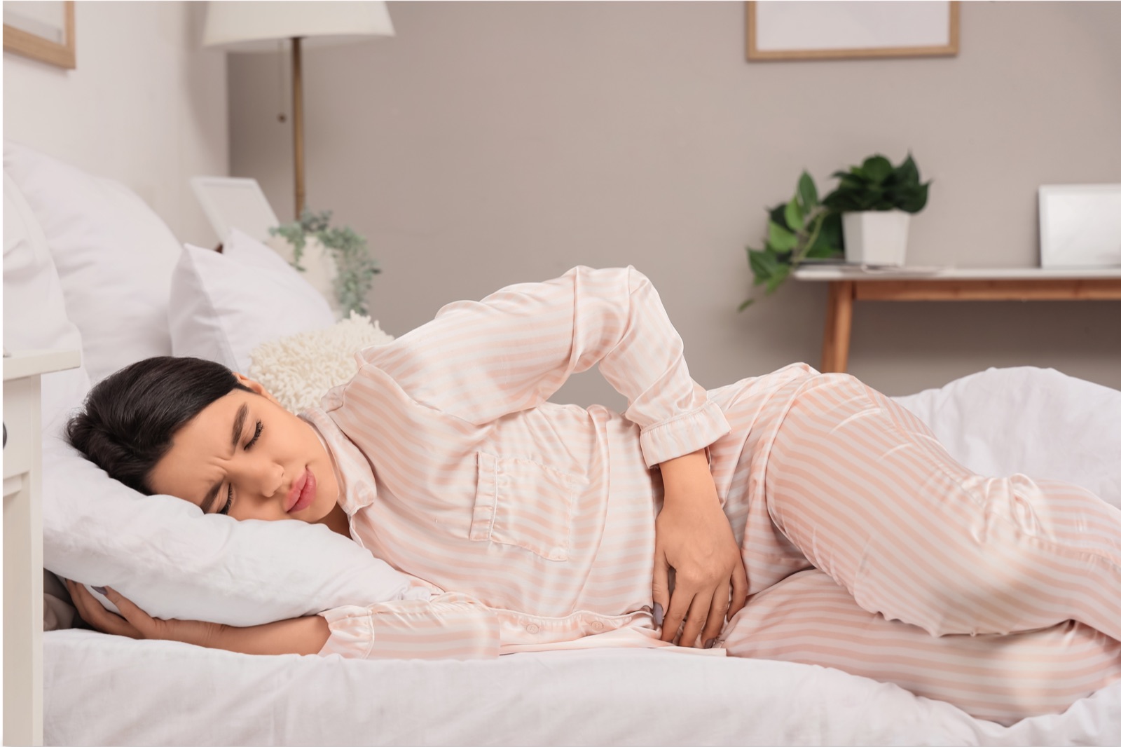 Person resting with lower abdominal cramps